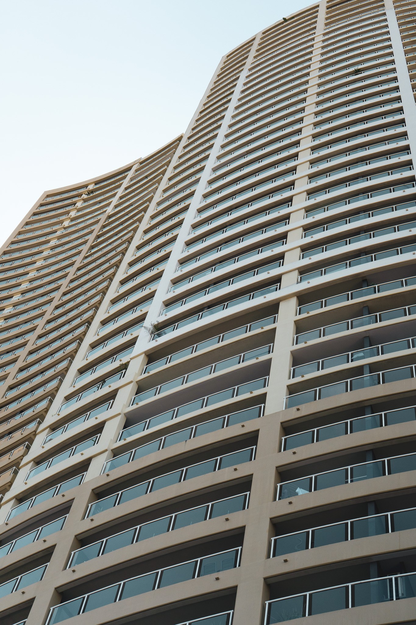 River Place residential tower viewed from below, showing its curved balconies
